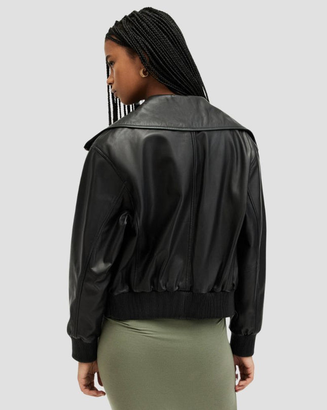 Person wearing a black leather jacket on a light gray background