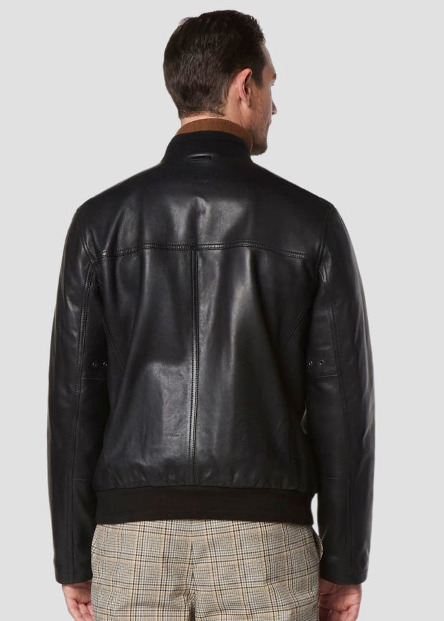 Man wearing a black leather jacket on a light gray background