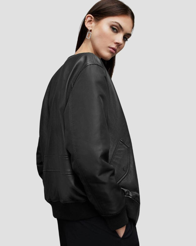Woman wearing a black leather jacket on a light gray background