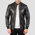Black leather jacket worn by a person on a gray background