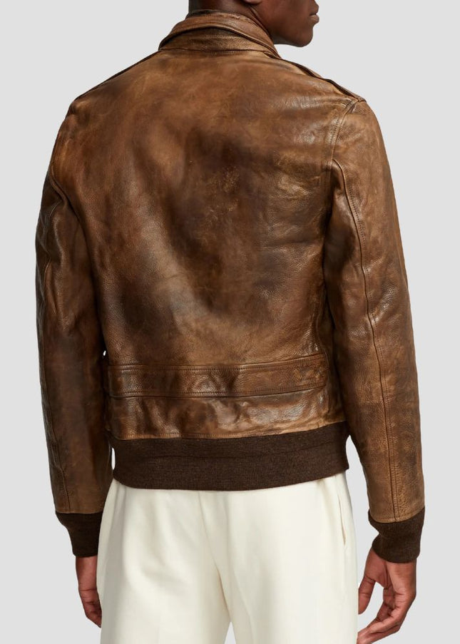Brown leather jacket worn by a person on a light gray background