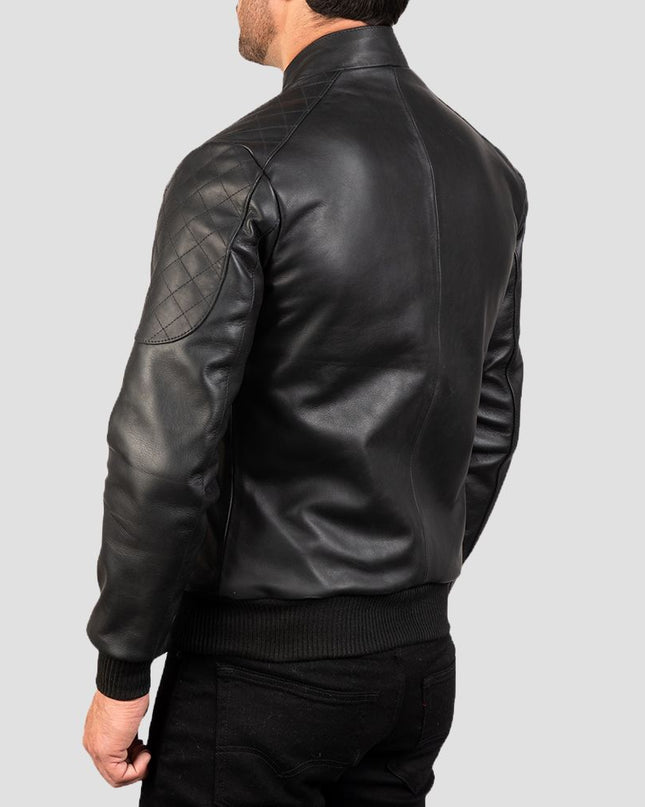 Black leather jacket worn by a person on a light gray background