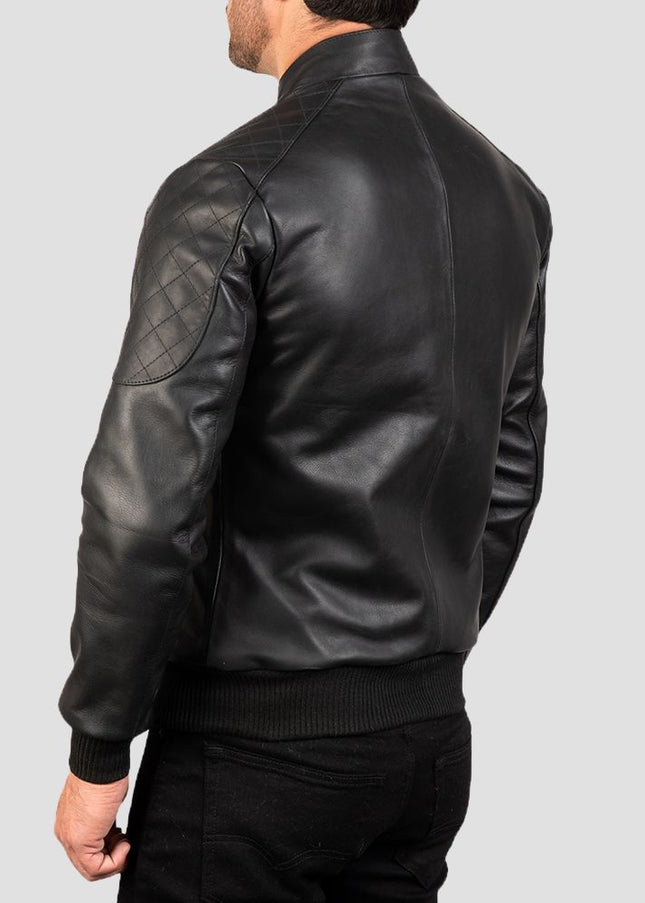 Black leather jacket worn by a person on a light gray background