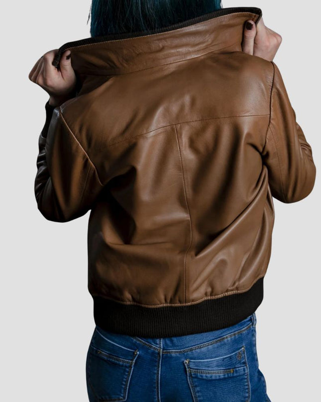 Brown leather jacket worn by a person on a plain background