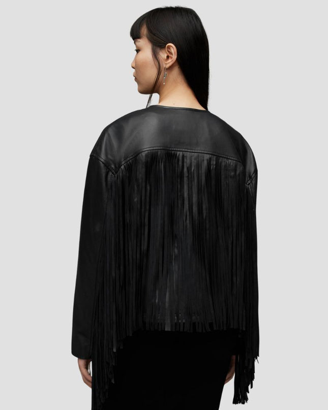 Black fringe leather jacket worn by a model on a light gray background