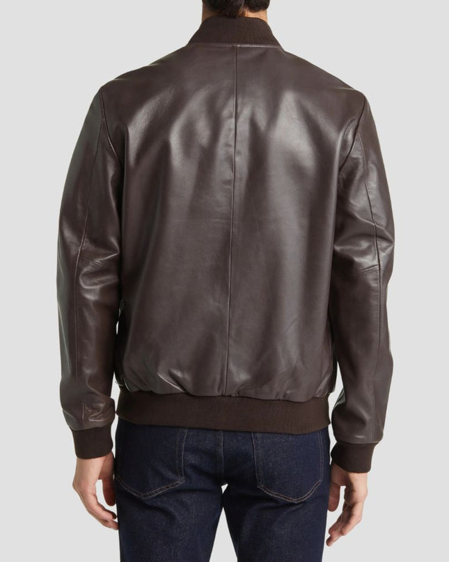 Brown leather jacket worn by a person on a light gray background