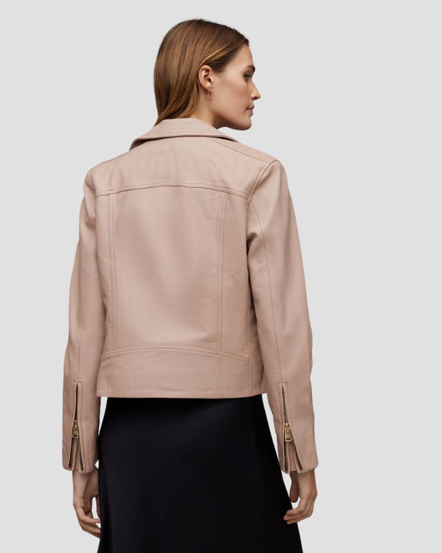 Woman wearing a beige leather jacket on a light gray background