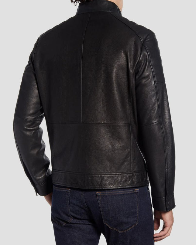 Black leather jacket worn by a person on a light gray background