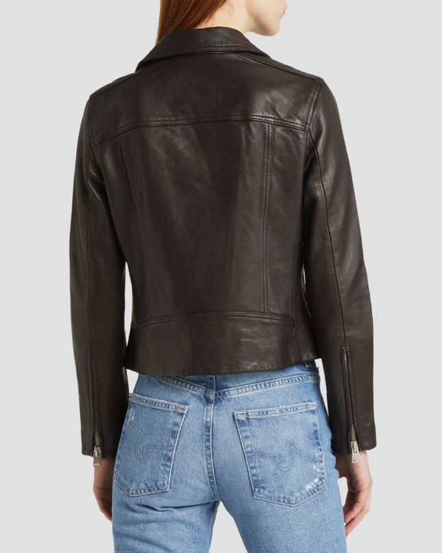 Person wearing a dark leather jacket and blue jeans on a light gray background