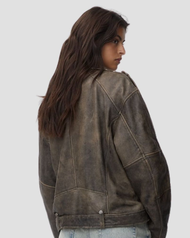 Person wearing a brown leather jacket on a plain background