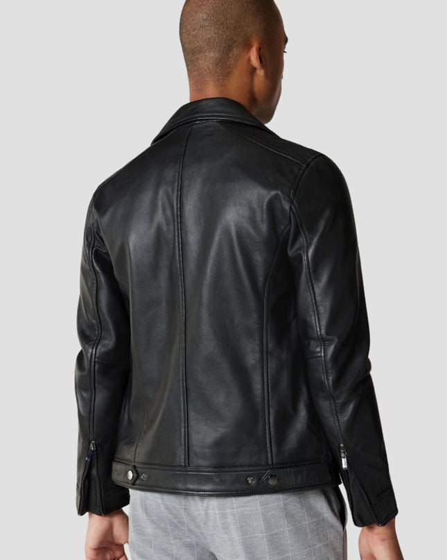 Person wearing a black leather jacket on a plain background