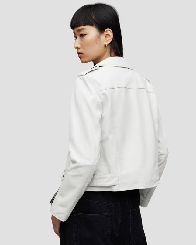 Person wearing a white jacket on a plain background