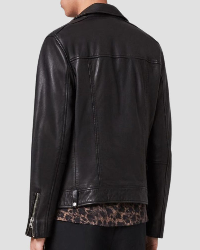 Black leather jacket worn by a person on a light gray background