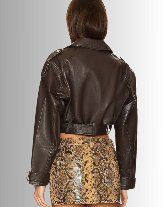 Person wearing a brown leather jacket and snake print skirt on a plain background