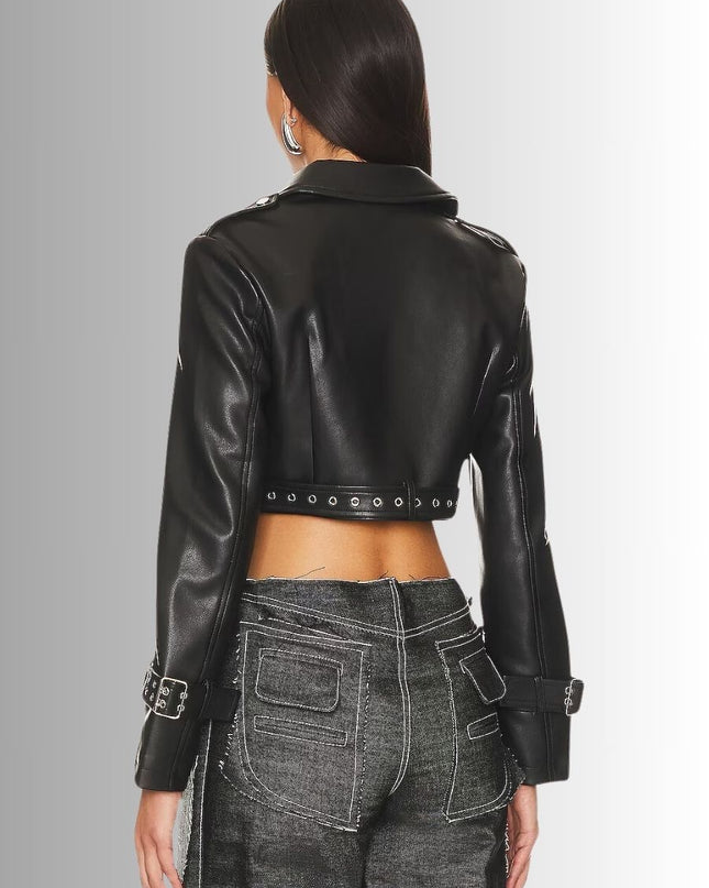 Person wearing a black leather jacket with studded details on a gray background