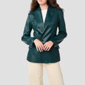 Person wearing a green leather jacket on a plain background