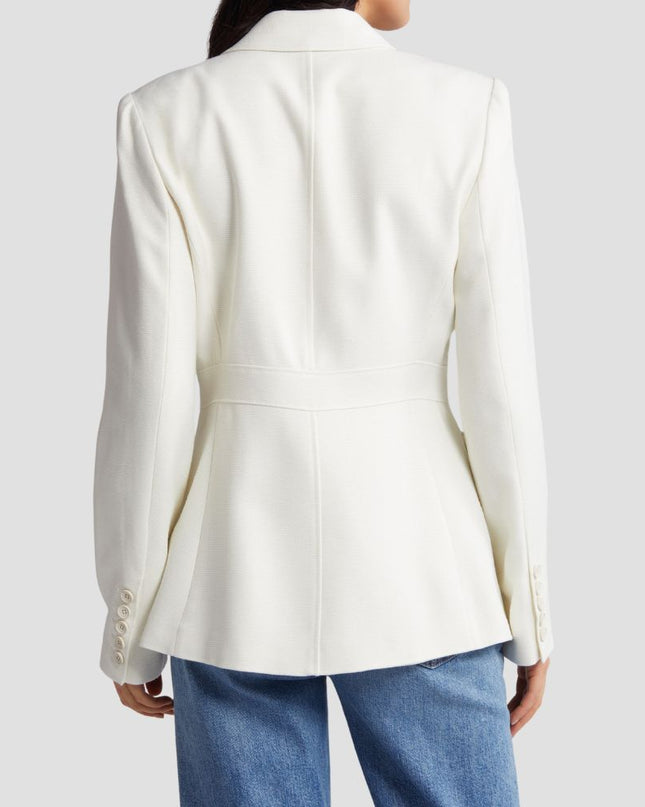 White blazer worn by a person on a light gray background