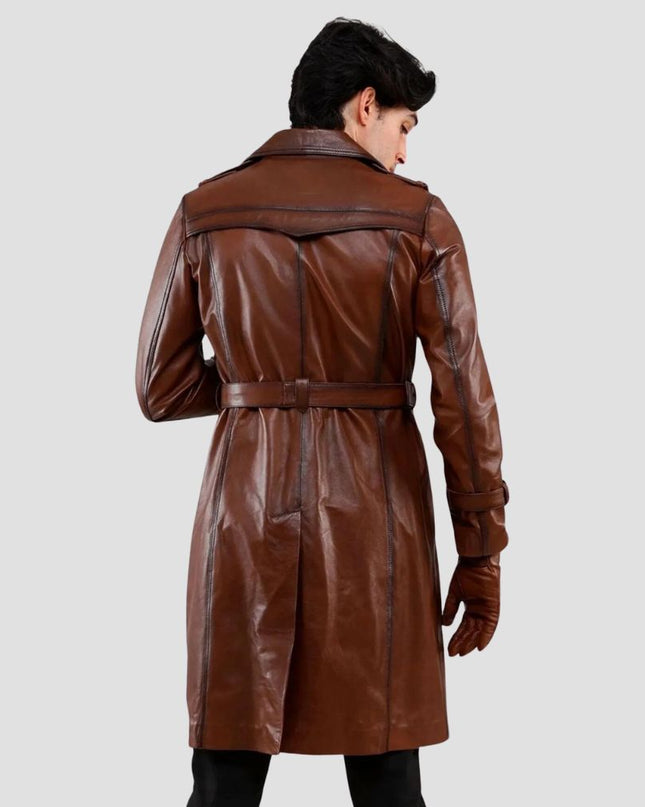 Man wearing a brown leather trench coat on a light gray background