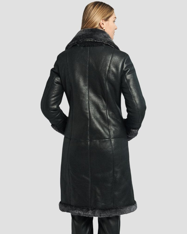 Woman wearing a black leather coat on a light gray background