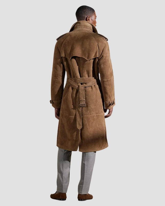 Man wearing a brown suede trench coat on a light gray background