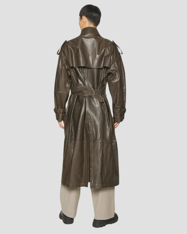Person wearing a brown leather trench coat on a white background