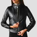 Black leather jacket worn by a person on a gray background