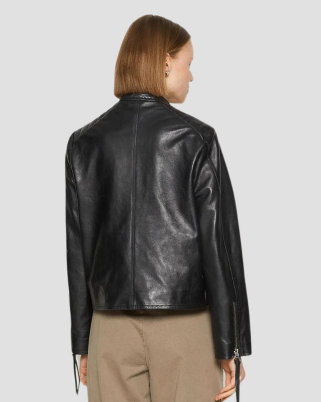 Person wearing a black leather jacket on a plain background