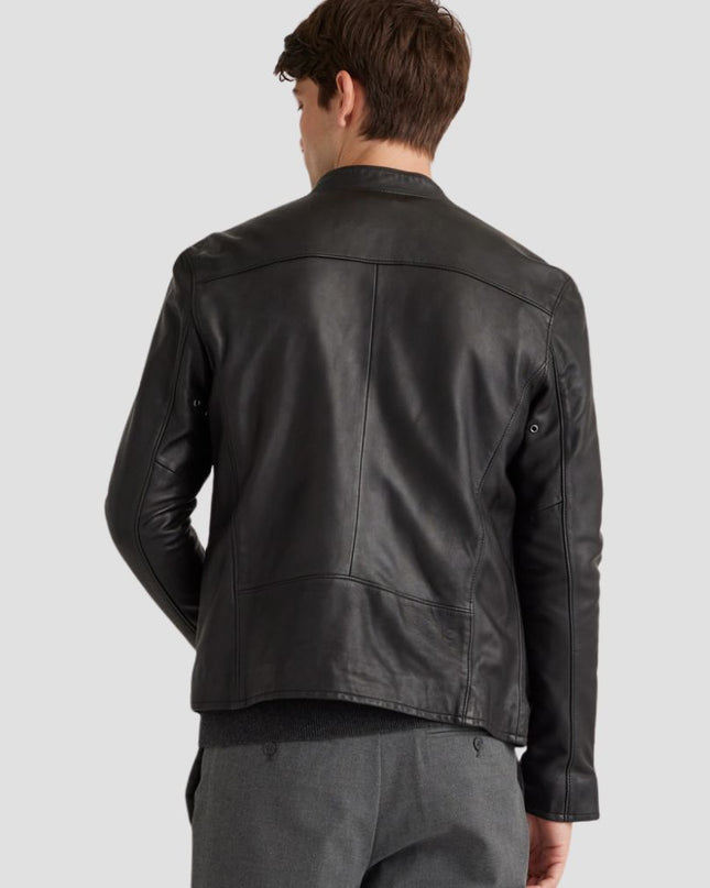 Man wearing a black leather jacket on a light gray background