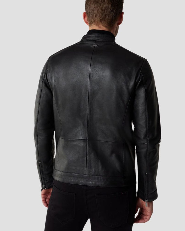 Person wearing a black leather jacket on a plain background