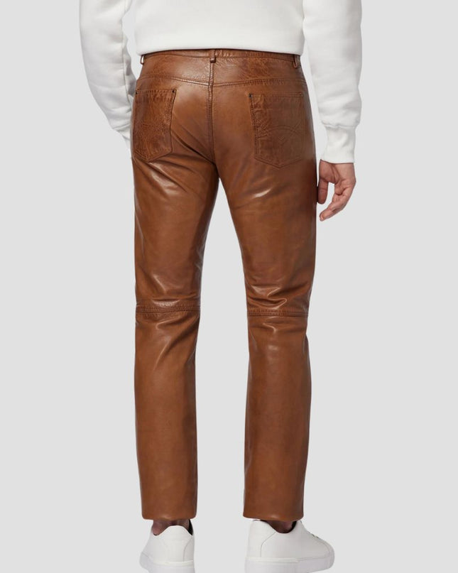 Brown leather pants worn by a person on a white background