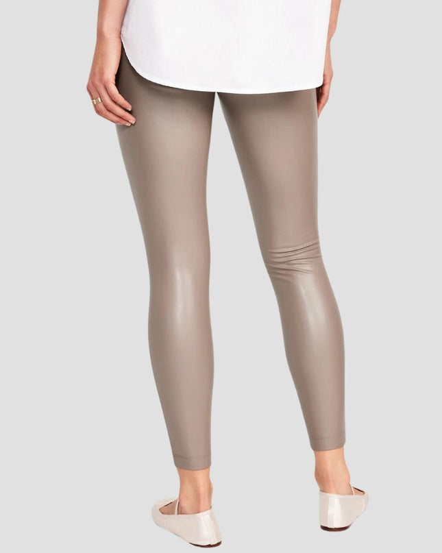 Person wearing beige leggings on a plain background