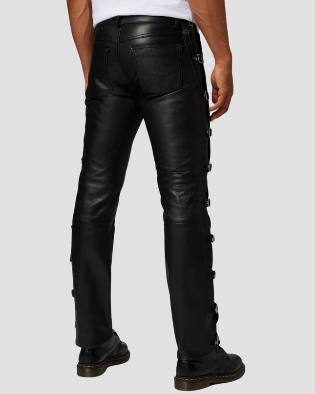 Black leather pants worn by a person on a light gray background