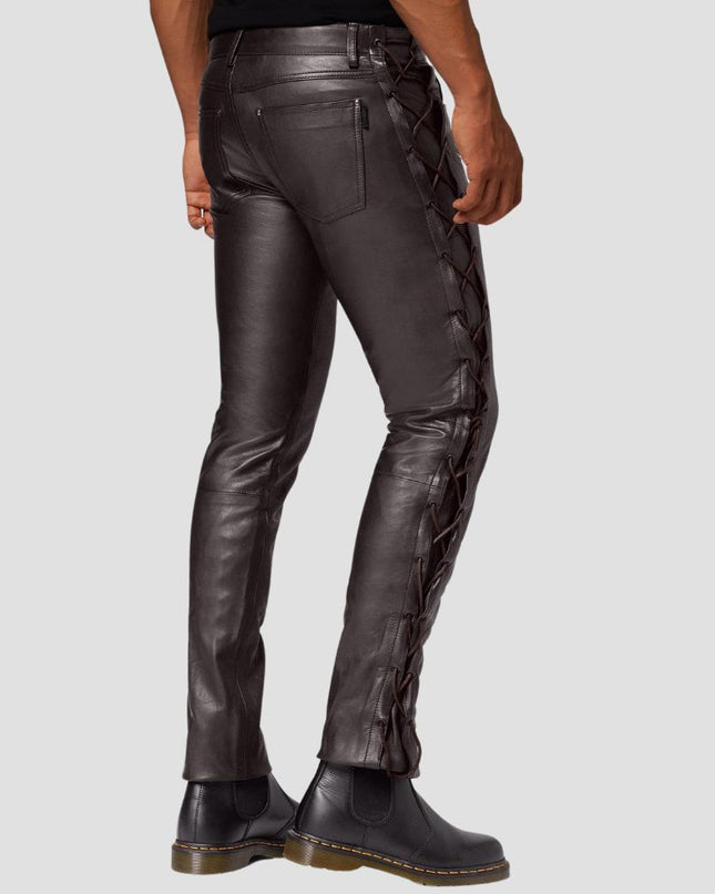 Black leather pants with lace-up design on a gray background