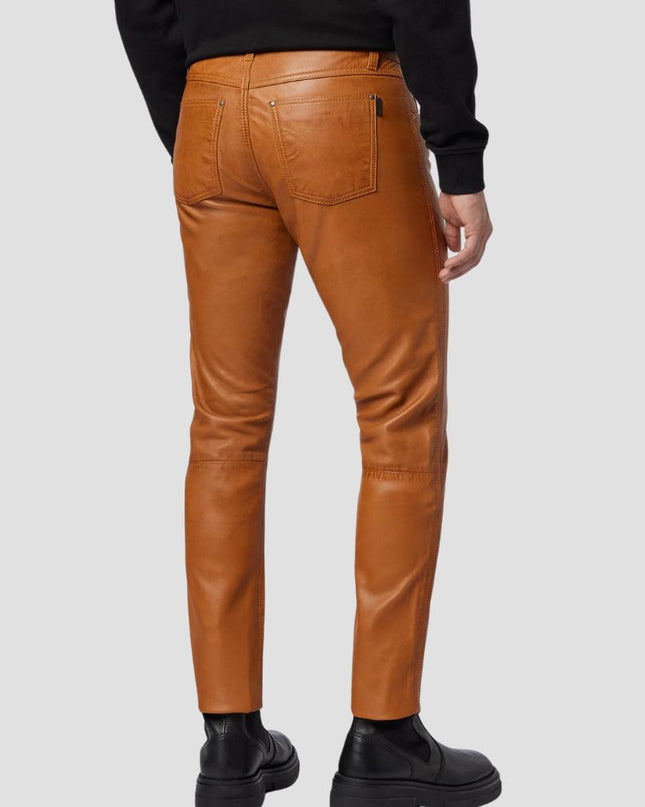 Brown leather pants worn by a person on a light gray background