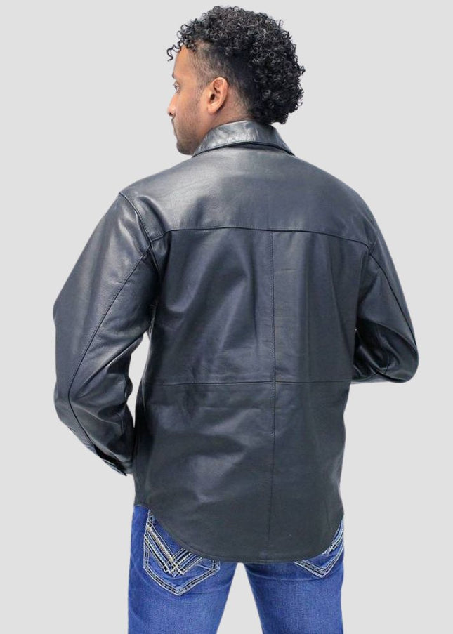 Person wearing a black leather jacket and blue jeans on a light gray background
