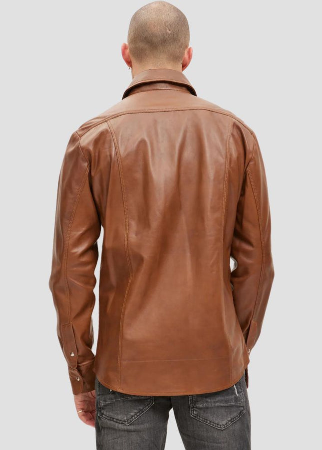 Man wearing a brown leather jacket on a gray background
