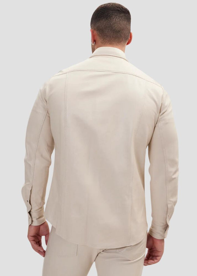 Man wearing a beige suit on a light gray background
