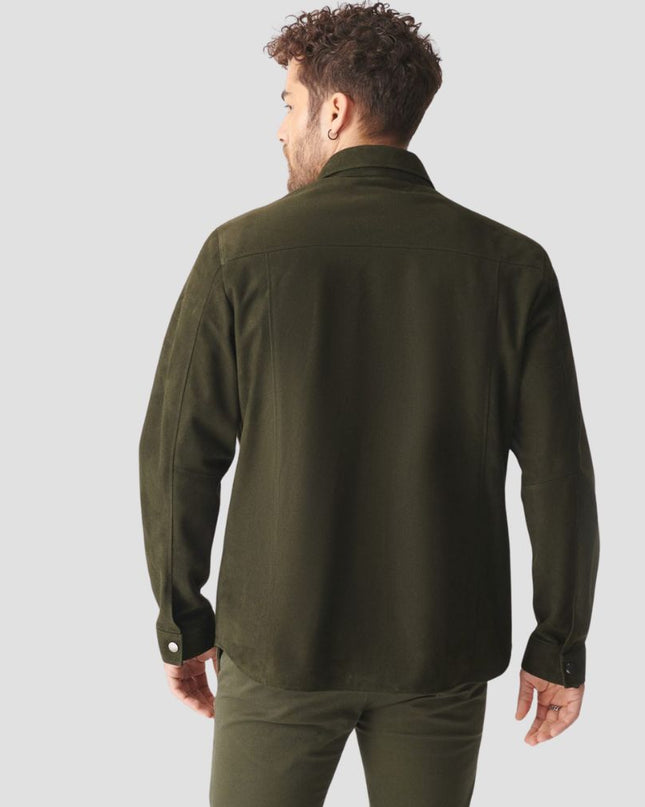 Man wearing an olive green shirt and pants on a light gray background
