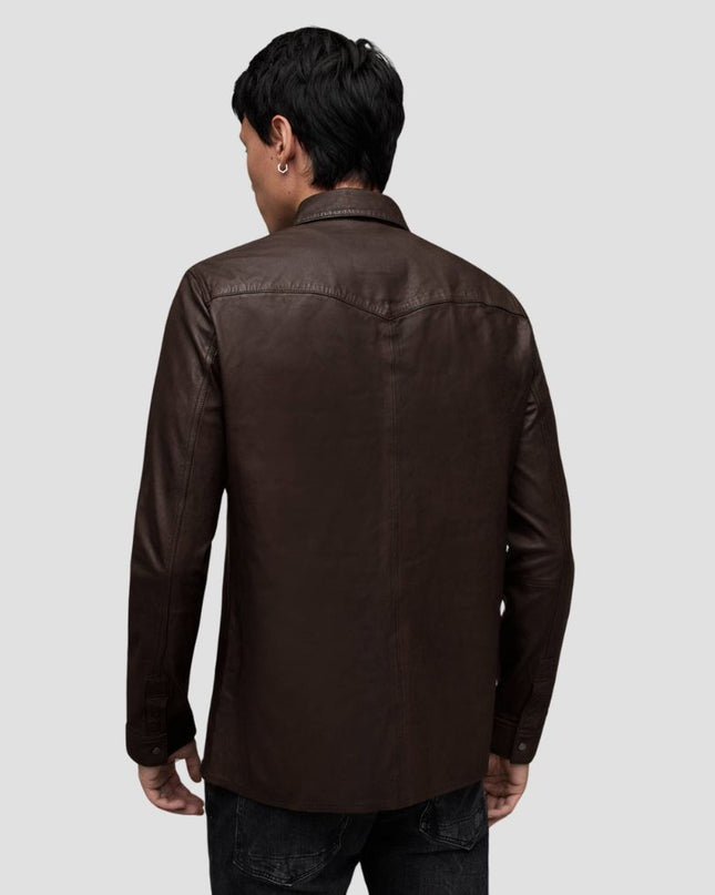 Man wearing a brown leather jacket on a light gray background