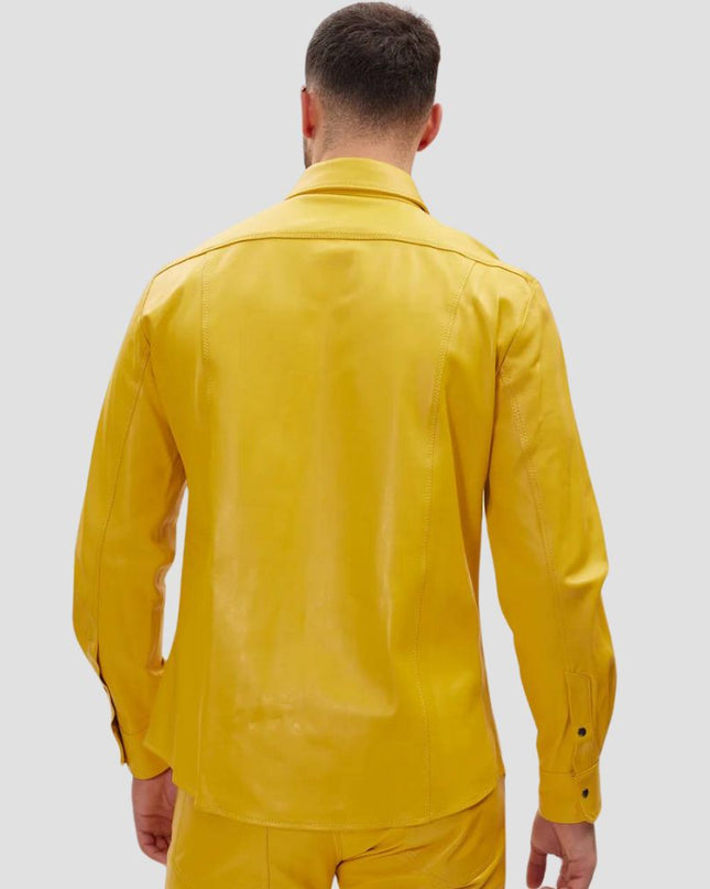 Man wearing a yellow raincoat on a plain background