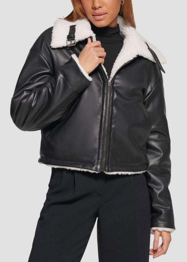 Black leather jacket with white fur lining worn by a person on a light gray background