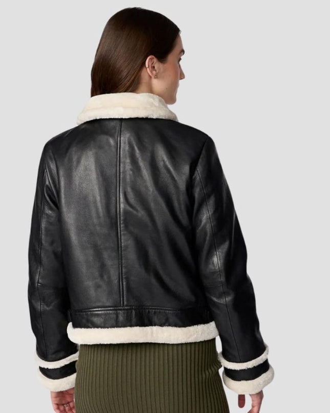Black leather jacket with white fur trim worn by a person on a light gray background