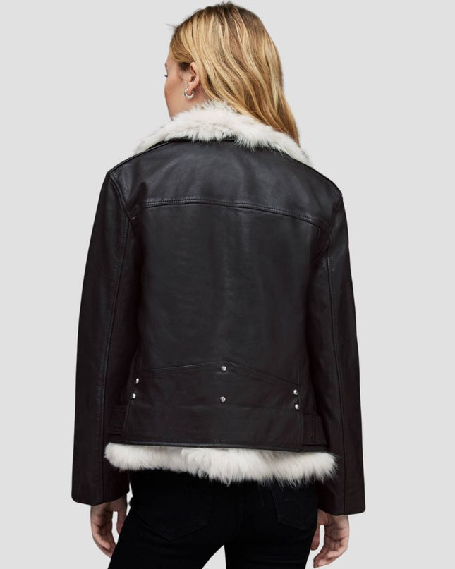 Black leather jacket with white fur trim on a plain background