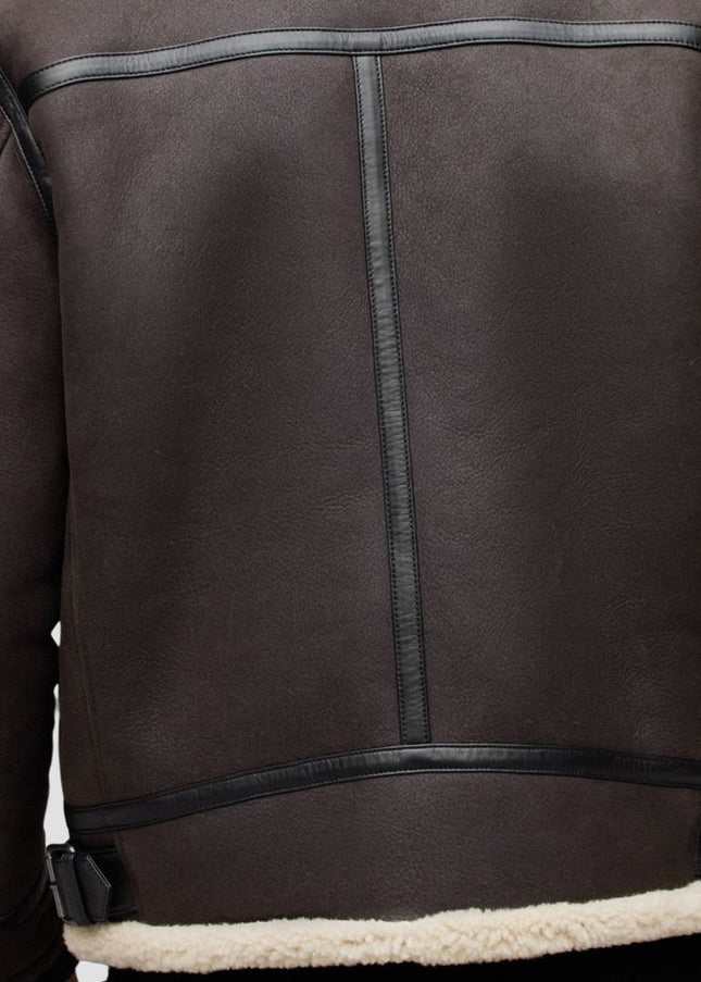 Brown leather jacket with black stitching on a white background
