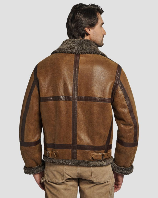 Man wearing a brown leather jacket with fur lining on a light gray background