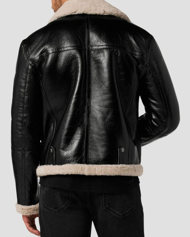 Black leather jacket with beige shearling collar and cuffs on a plain background