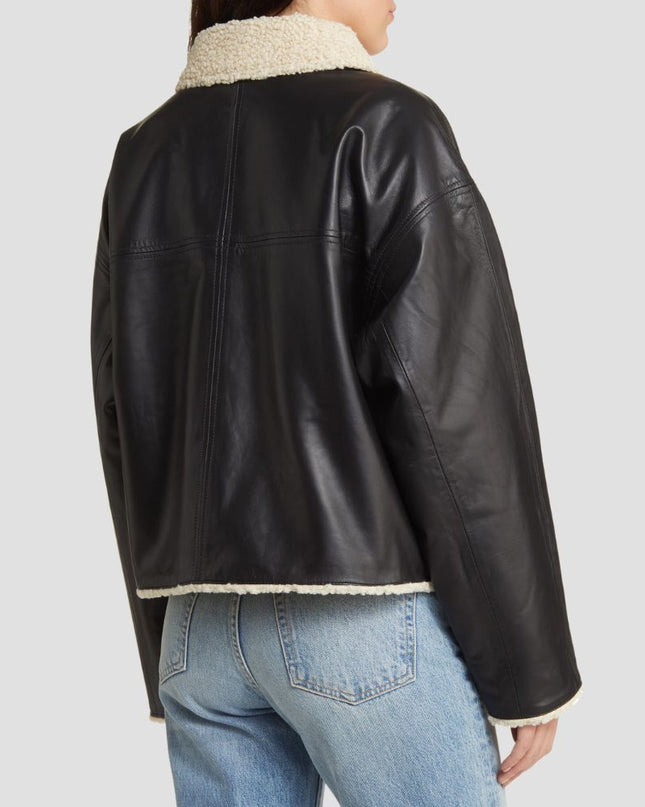 Black leather jacket with white fur lining worn by a person on a light gray background