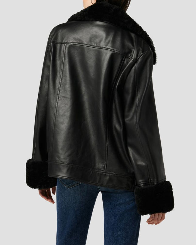 Black leather jacket with fur trim on a plain background