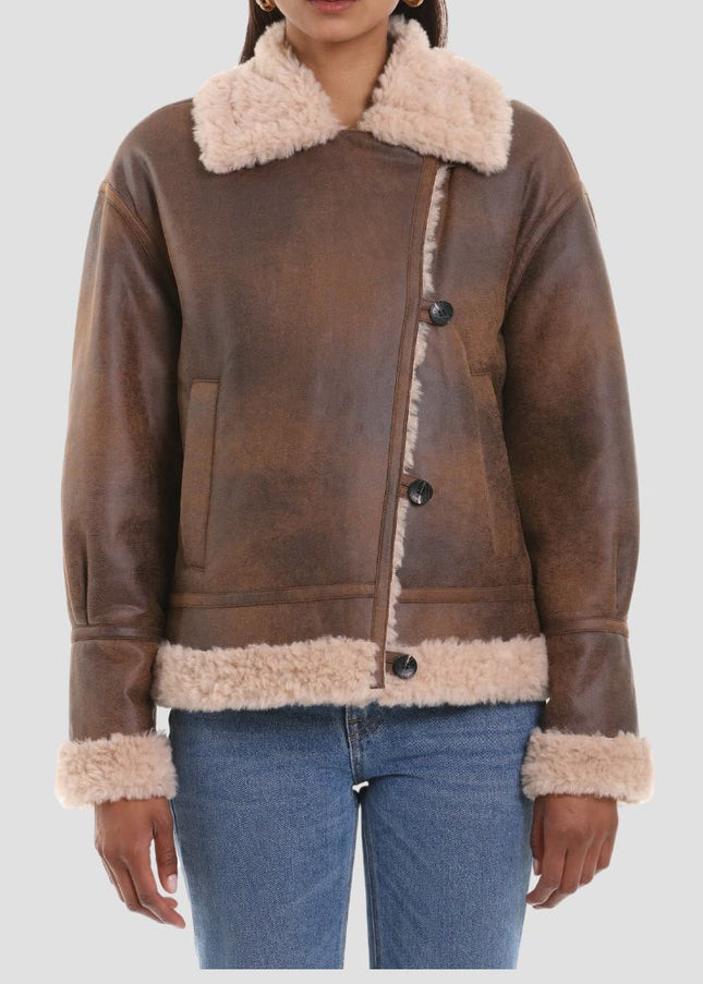 Brown leather jacket with beige fur lining worn by a person on a white background