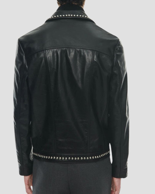 Black leather jacket with studded details on a gray background